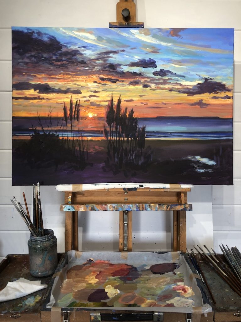 Woolacombe sunset painting on a studio easel